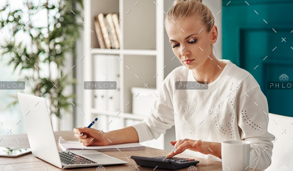 demo-attachment-469-concentrated-woman-budgeting-at-office-RVS7TEP